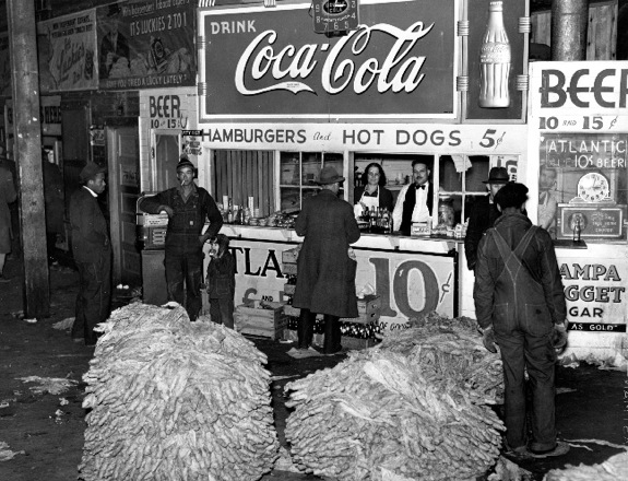 “Lunch stand and tobacco inside entrance to warehouse at end of auction sale, Durham, North Carolina, November 1929.”